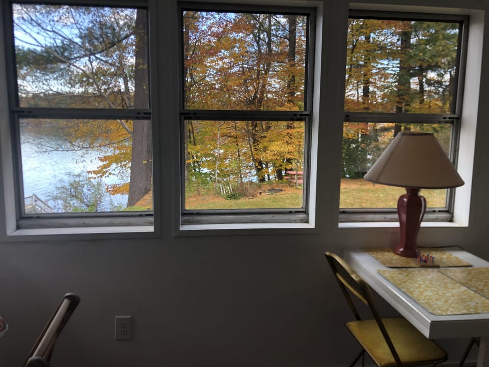 Cottage overlooks lake and gardens. Path to private waterfront area with firepit