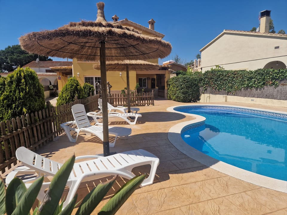 Relax on the sun loungers underneath the straw umbrellas right by the large private pool at holiday home Eva. Book your summer stay now!