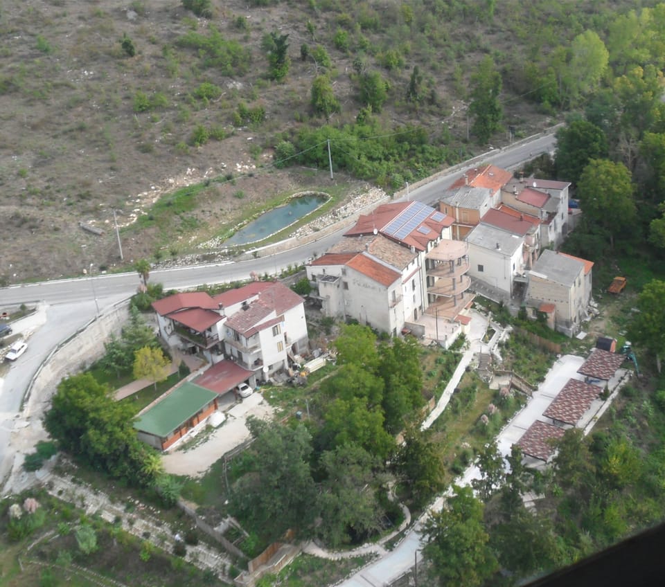 aerial property and surrounding homes and parking lot with car ports