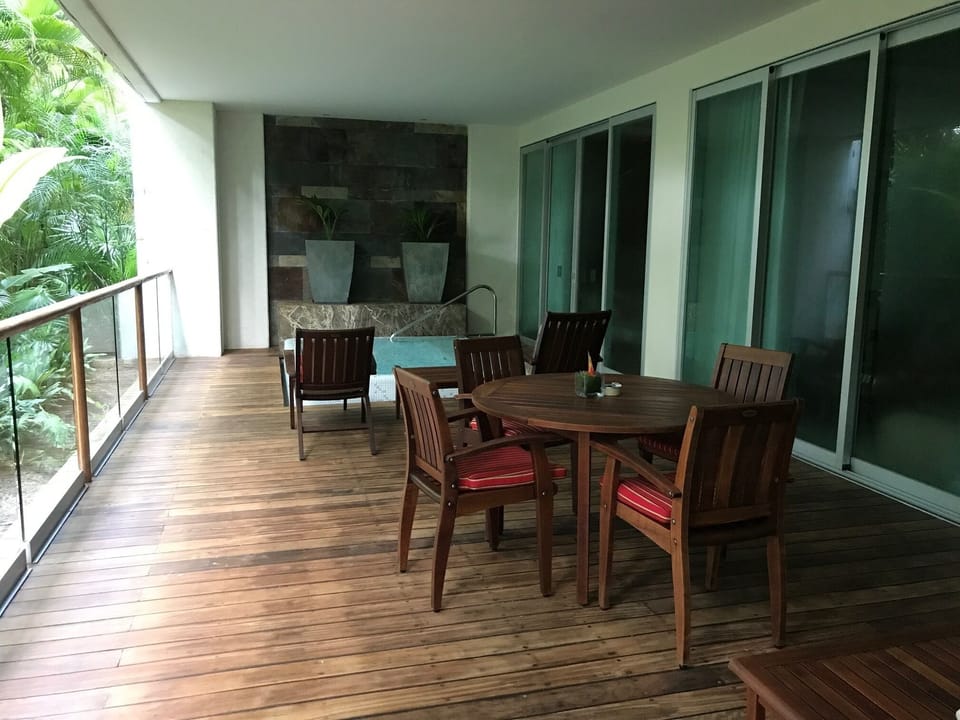 Balcony with dining table and private swimming pool