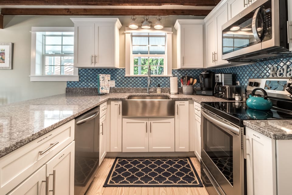 Fully stocked kitchen with custom-built cabinets and stainless steel appliances