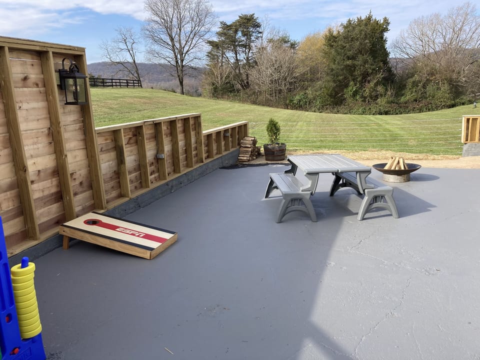 Party patio, with corn hole, firepit, picnic tables, other games.  Great views.