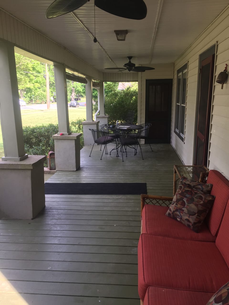 Front porch with fans and lots of seating, table, gardenias, herbs, flowers 
