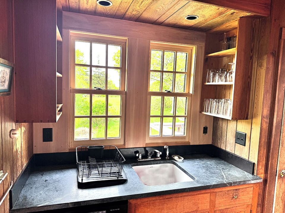The kitchen sink area including a dishwasher below