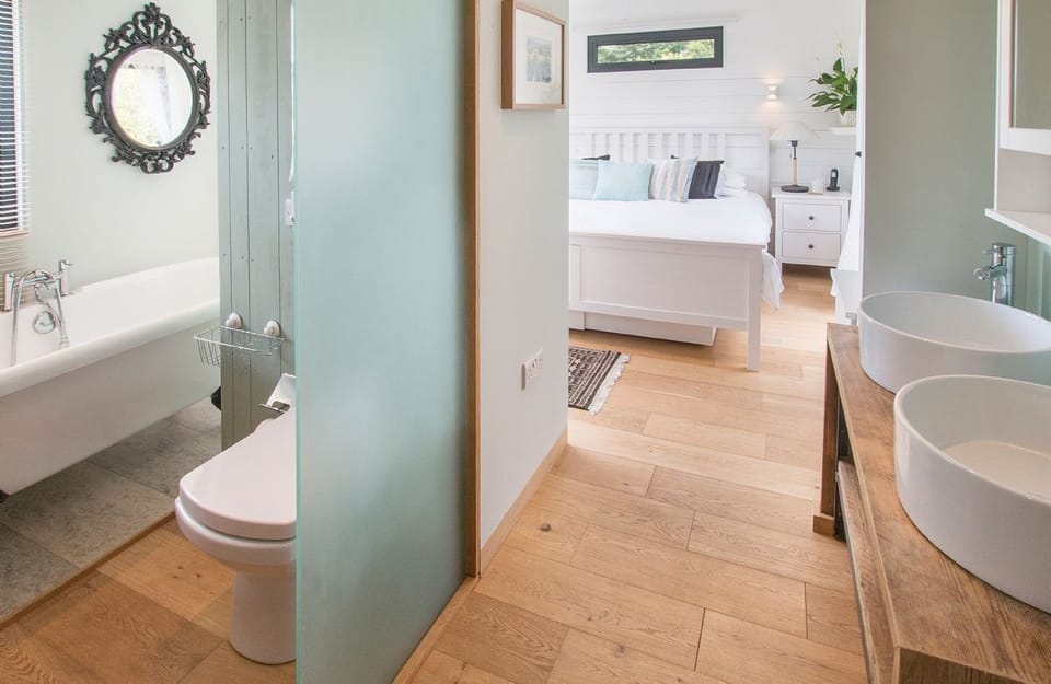 Ground floor:  Open-plan en-suite bathroom with roll-top bath and separate shower - there is a partition, rather than a door between the bedroom and bathroom areas