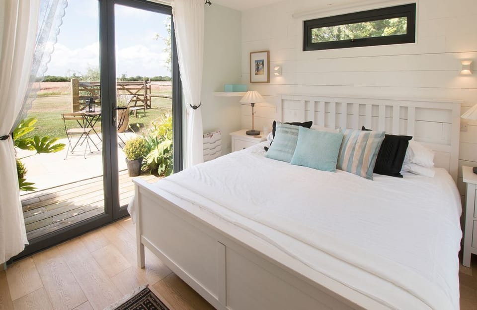 Ground floor:  Bedroom (accessed via covered access) with a super-king size bed and french doors to terrace and hot tub