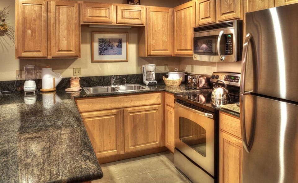 Master unit's full kitchen with breakfast counter