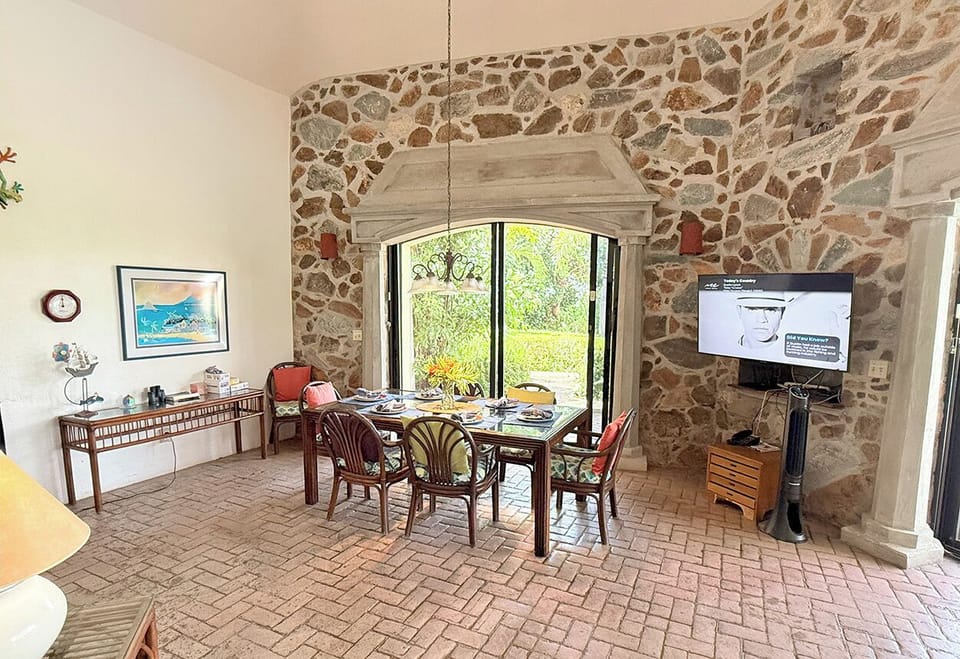The interior dining table looks out to the pool and sun deck