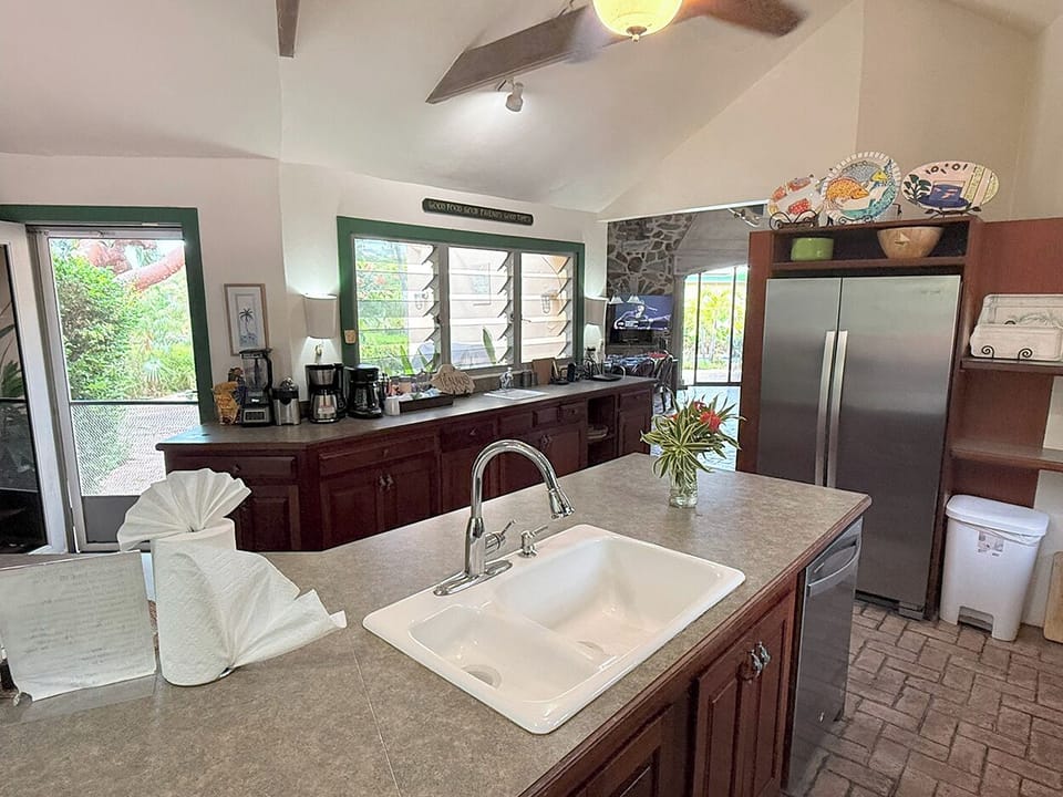 The kitchen has a door out to the pool and sun deck 