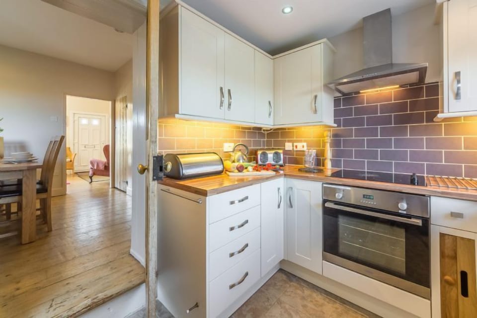Ground floor: Kitchen, leading to dining room and sitting room
