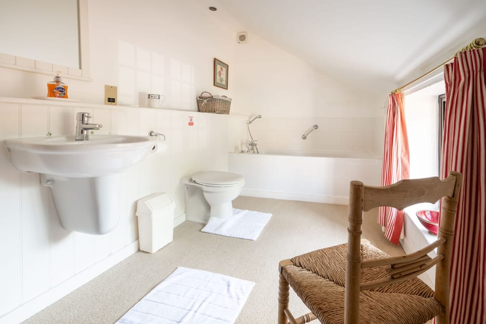 First floor; The family bathroom has a bath and hand-held shower