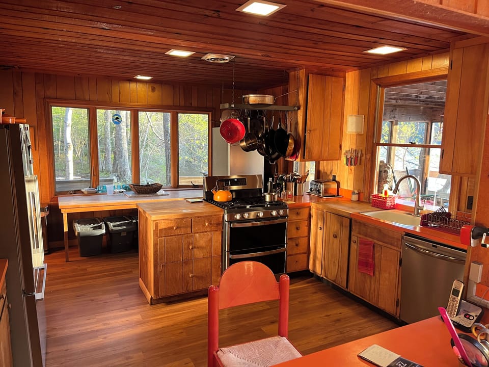 Large kitchen with eat-in counter and food prep area, water views on two sides