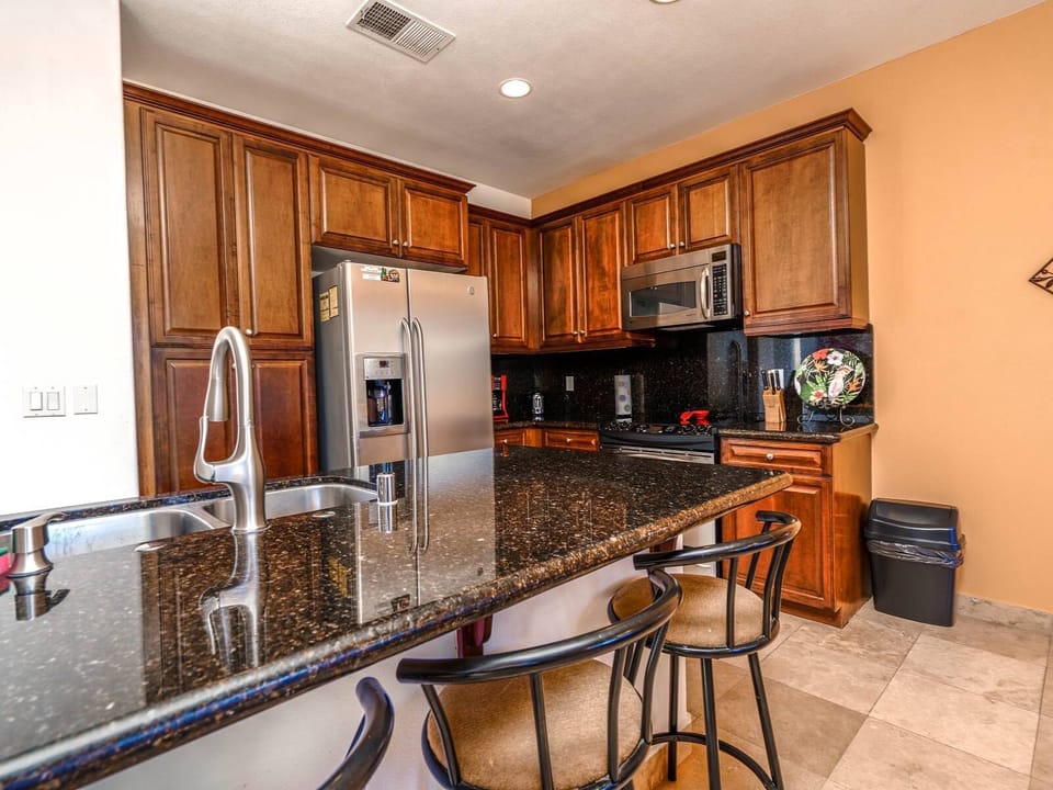 Ground-floor condo in El Dorado Ranch with full kitchen, two bedrooms, two bathrooms, and a private patio — near heated pools and golf course.
