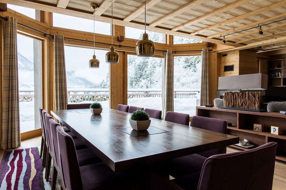 Dining table positioned in front of glass doors onto terrace