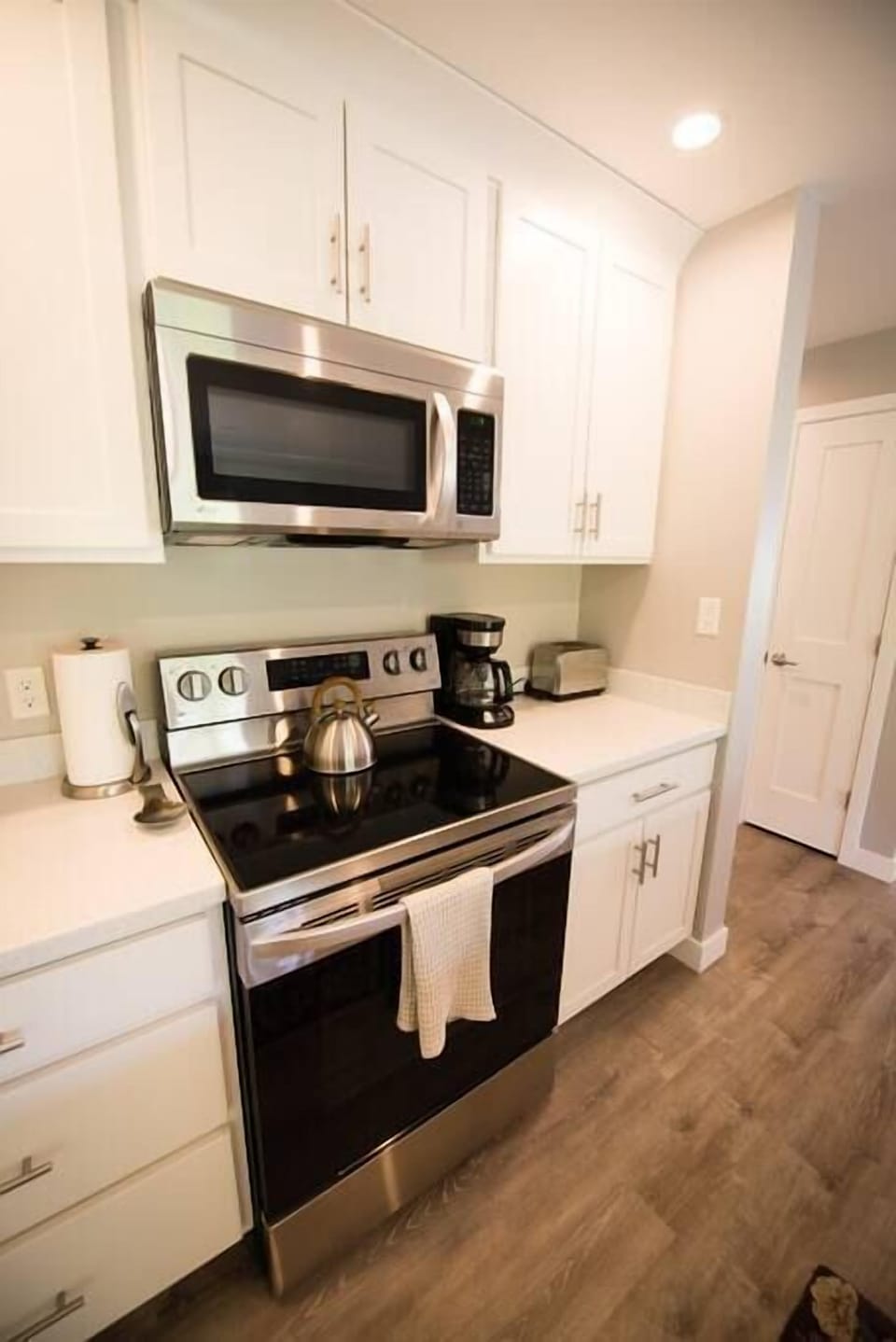 Glass cook top range with kettle, coffee maker, and toaster