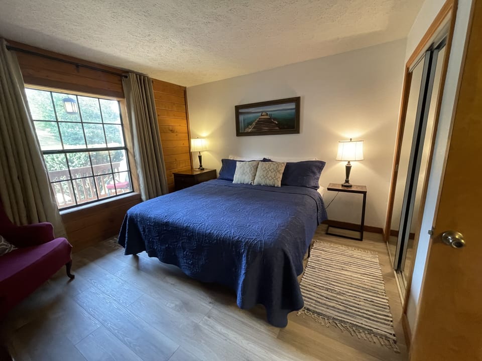 Master bedroom NEW FLOORING SEPT 2023~ King bed with chair and flat screen tv
