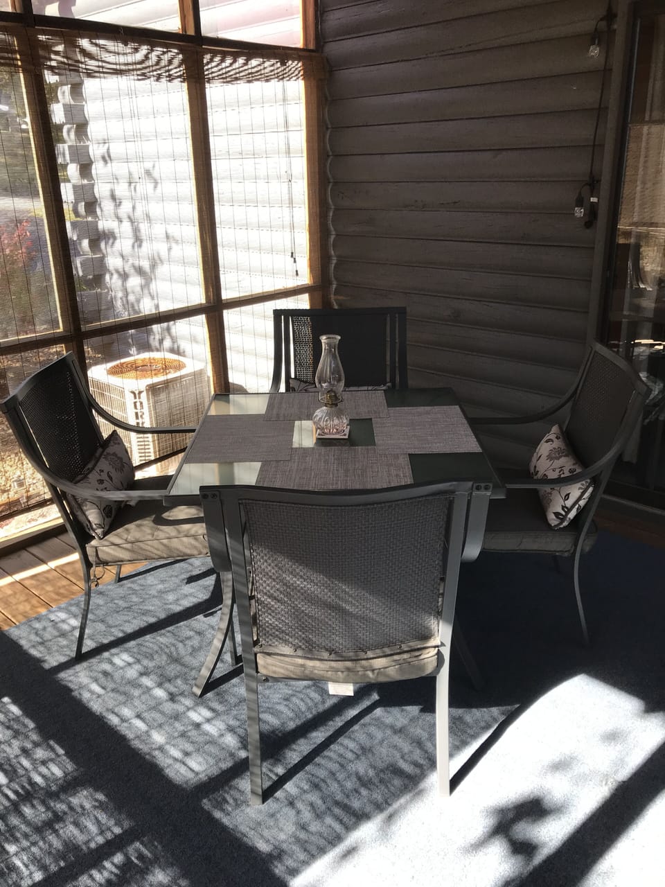The beautiful and tranquil 4 seasons room - screened in, of course. Dine outside