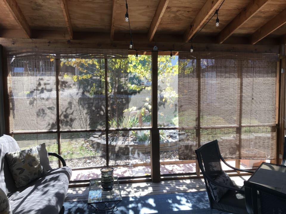 Enjoy coffee and relax with a good book in this screened in back porch