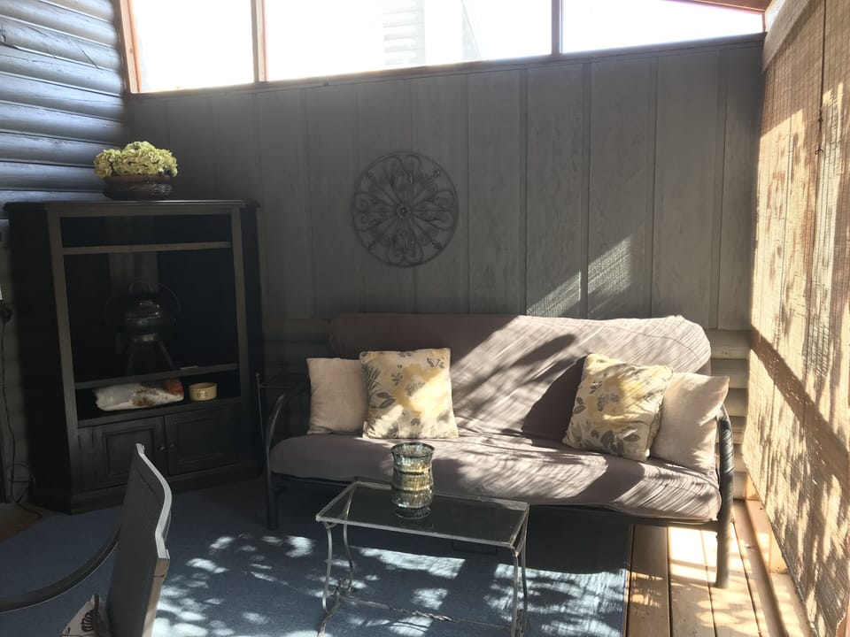 The beautiful and tranquil 4 seasons room - screened in, of course. Dine outside