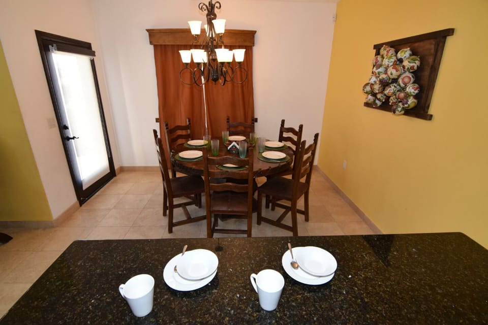 Dedicated dining area with seating off the living room and kitchen — perfect for group meals .
