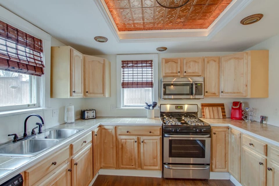 The stainless steel appliances gleam in the bright, well-appointed kitchen.