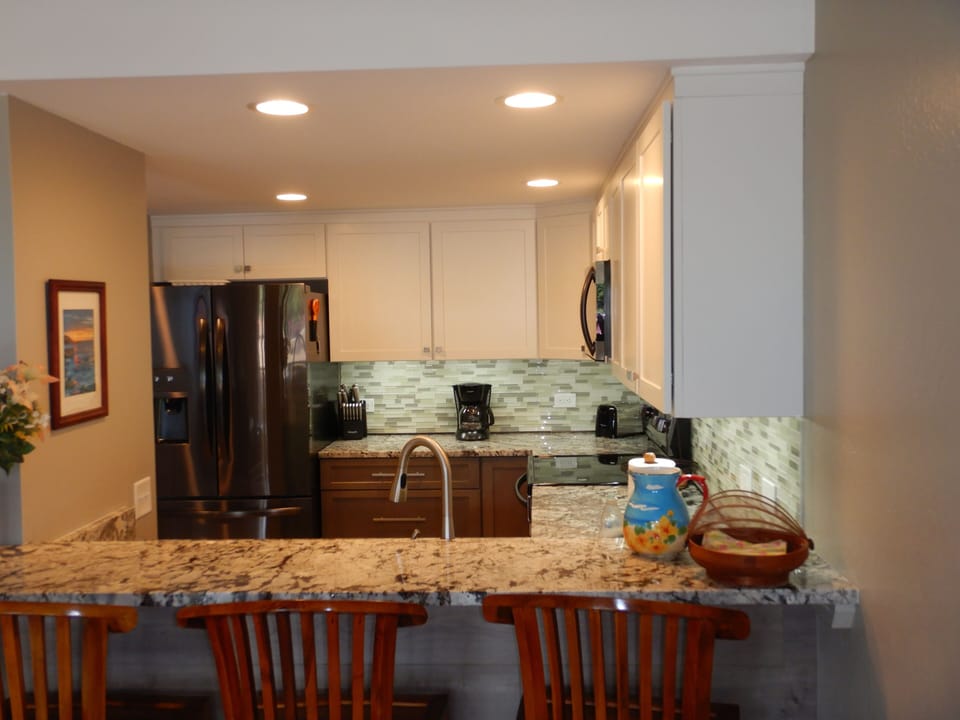 Kitchen with large refrigerator and filtered water and ice on the door.