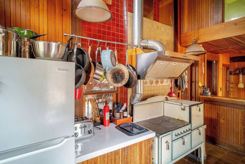 West-facing wall of kitchen shows propane-converted Wedgewood stove & oven