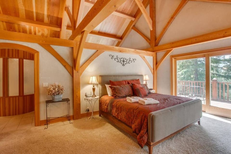 Upstairs master bedroom features a private deck with mountain view