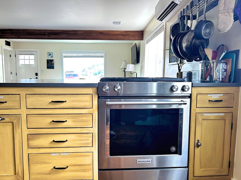 Open kitchen work space with barstools on the othe side.