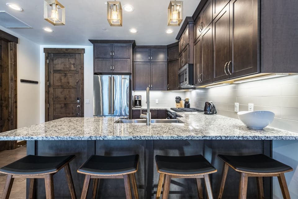 Counter stools add seating in kitchen.