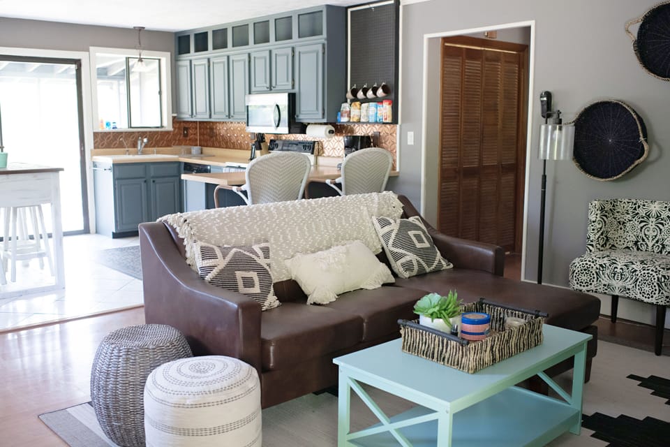 Comfortable den with open concept kitchen leading out to a screened in porch