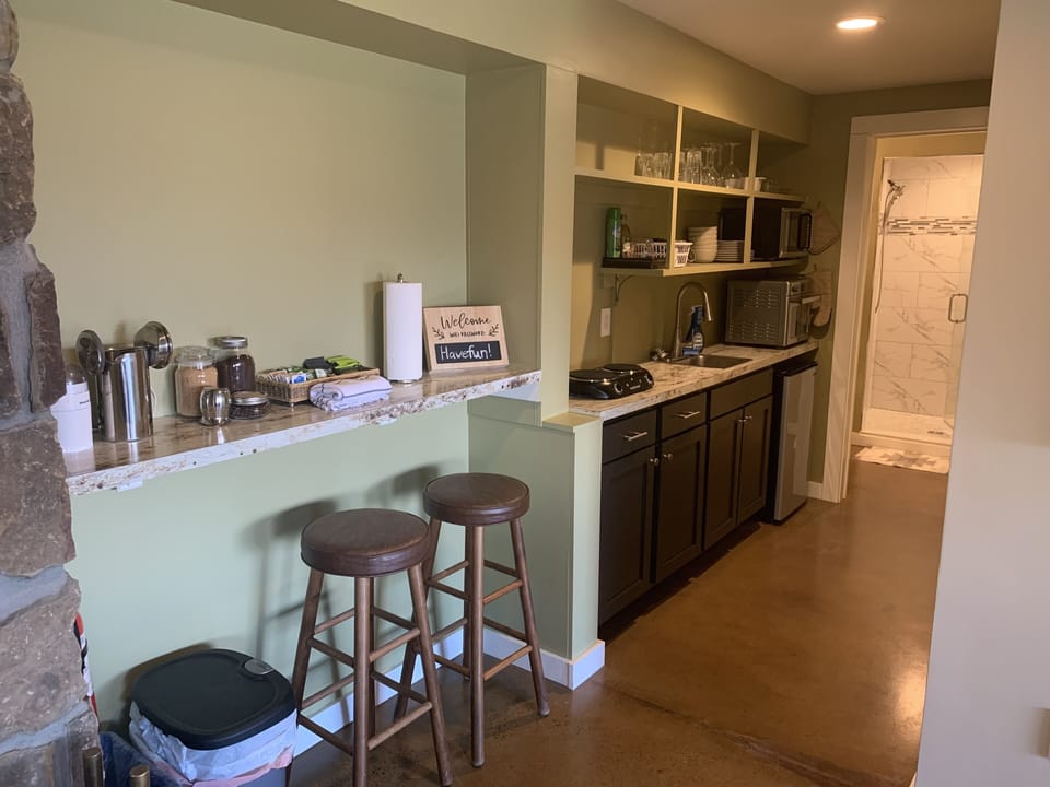 Kitchenette showing sink and plug in stove top