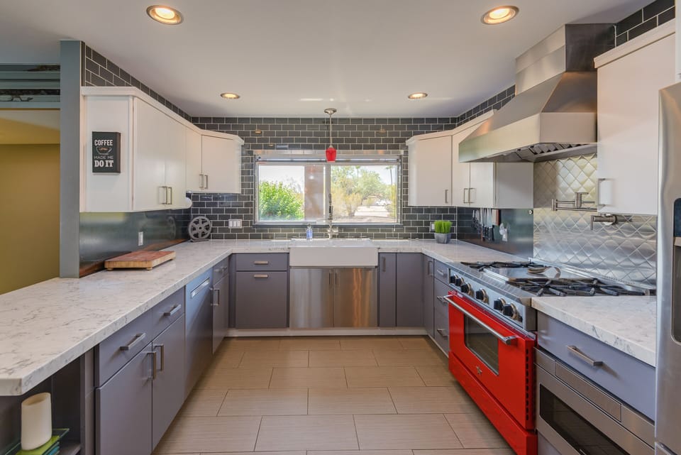 Custom kitchen with all stainless appliances, commercial style gas stove