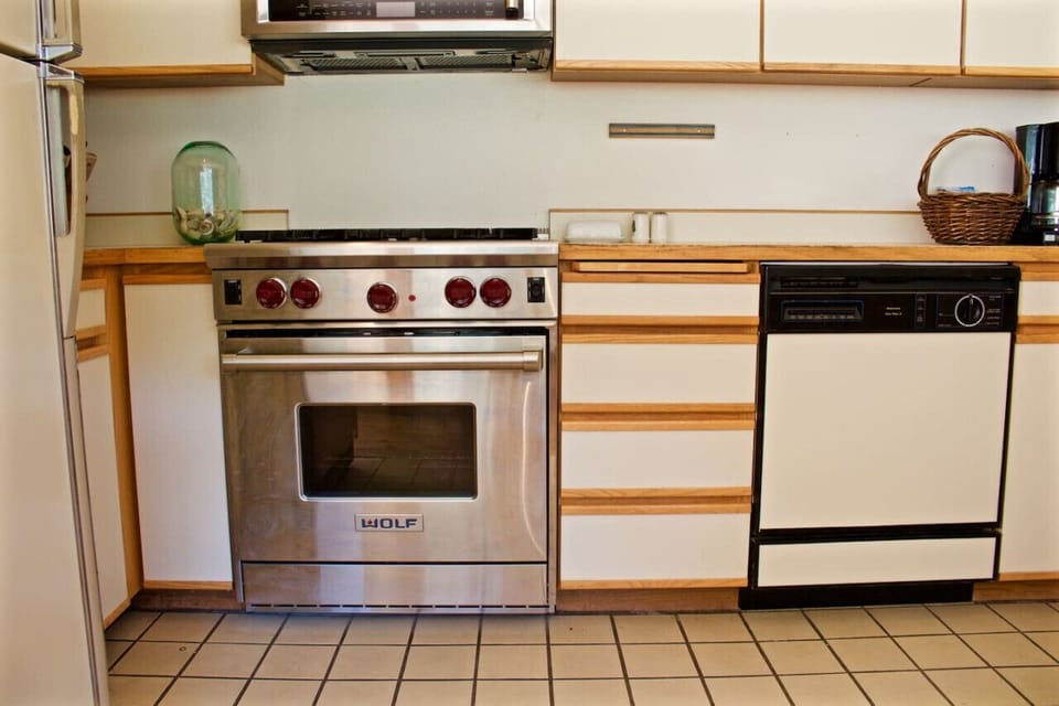 Updated WOLF oven and stove, dishwasher is located on the right