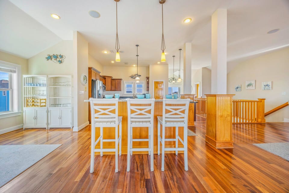 Your spacious kitchen invites culinary adventures with rich hardwood floors, granite countertops, and an island perfect for morning coffee or evening wine.