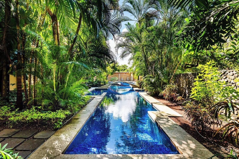 Shared pool and lush gardens at La Esquina 3 in Playa Langosta, Costa Rica. Family-friendly turquoise pool steps from beach walks. Professionally managed by Tropical Vacations by RPM. Book direct to save fees.