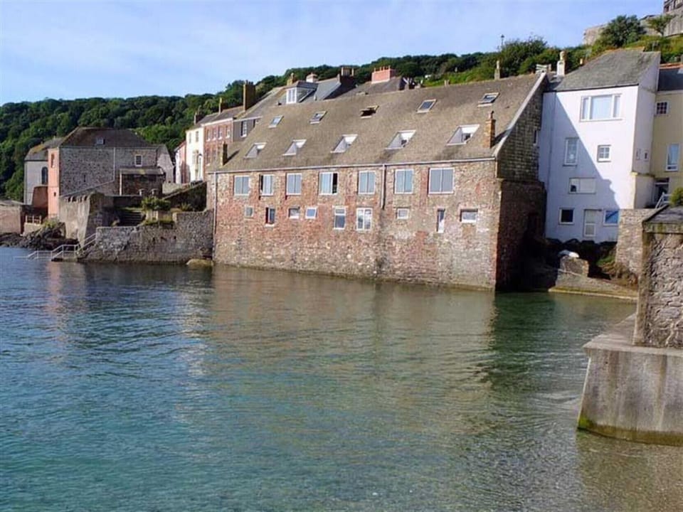 View of cottage from beach with tide in