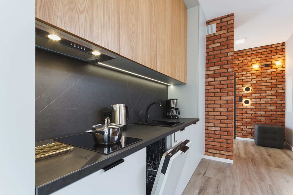 Kitchenette with dishwasher and refrigerator. 
