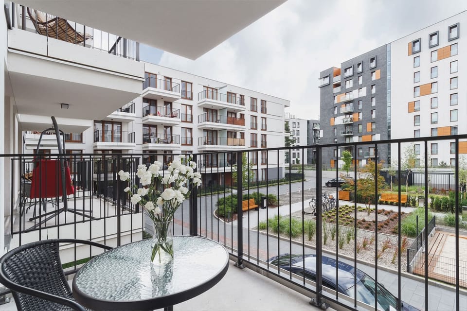 Furnished balcony with green surroundings. 