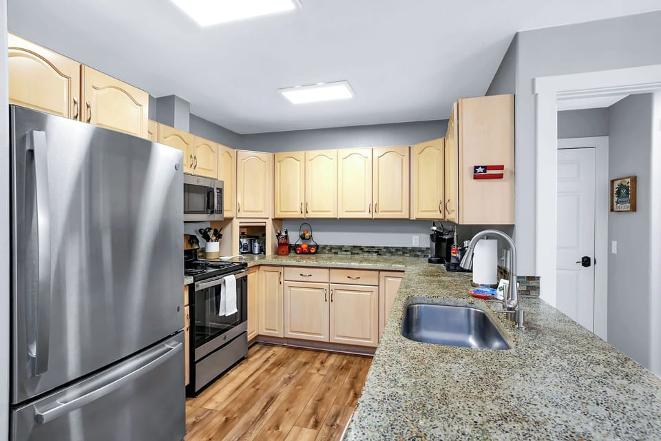 Our kitchen has stainless steel appliances and concrete countertops.