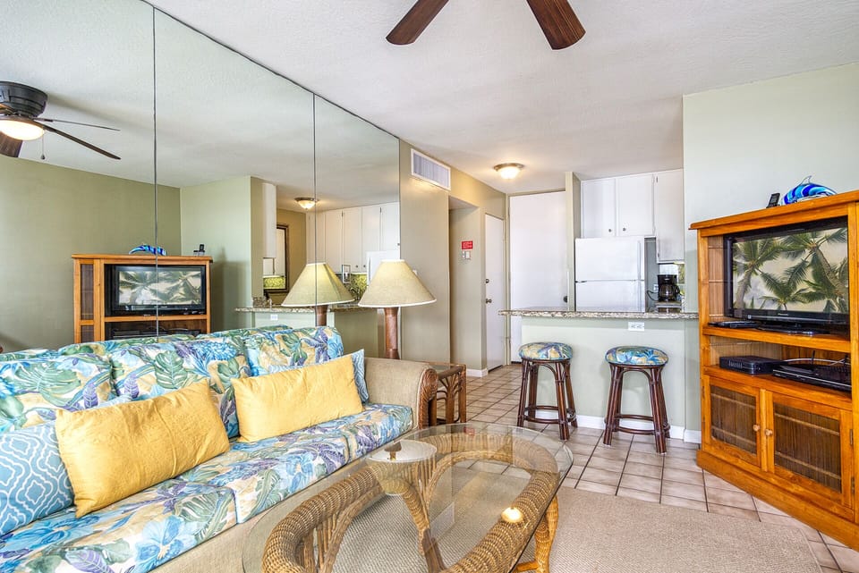 Relax in a bright living area with central A/C, ocean views, and a queen sofa bed for extra sleeping space.