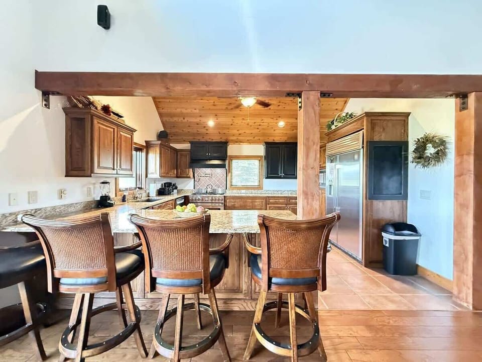 The open kitchen blends seamlessly into the cabin's cozy living area, creating a welcoming space perfect for gathering and unwinding.