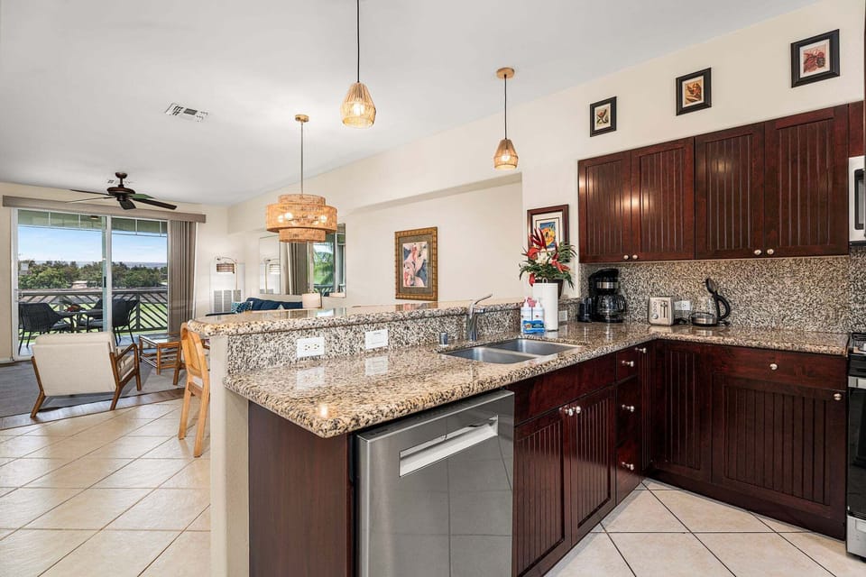 The kitchen is equipped with natural stone countertops and modern appliances