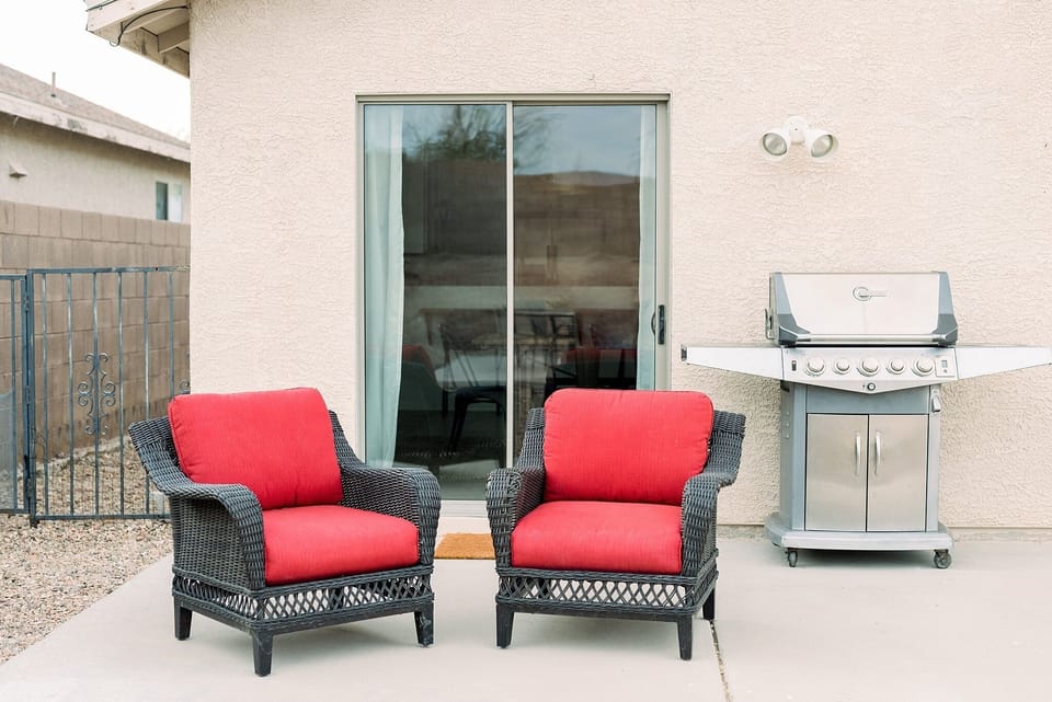 Patio chairs, a grill, and a separate dining area- perfect for an evening BBQ
