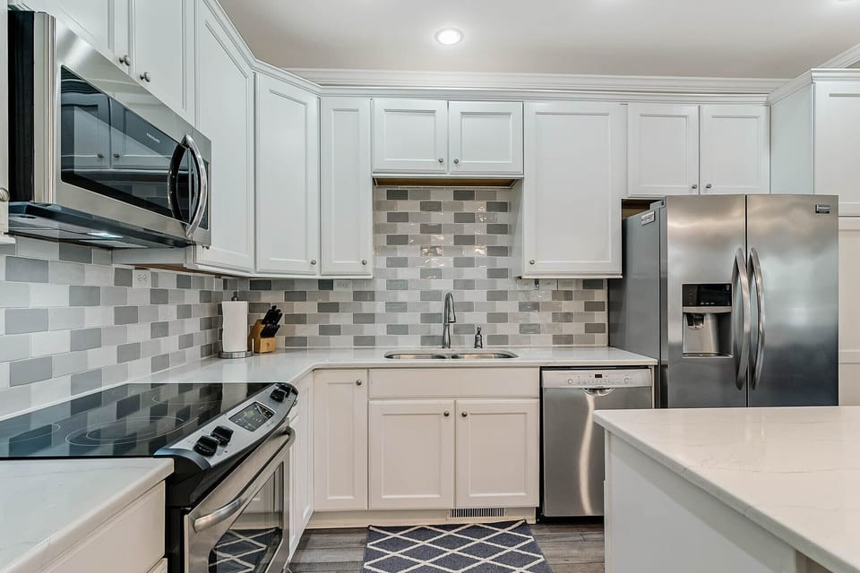 Kitchen equipt with microwave, range, dishwasher, and refrigerator.