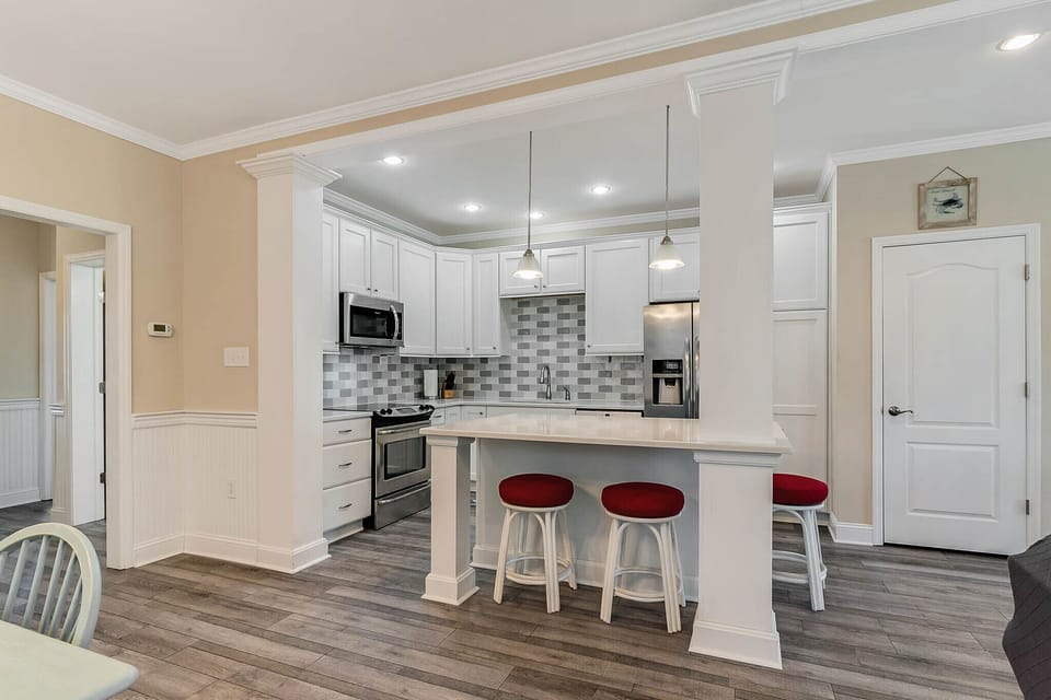 Looking into the kitchen. Setting around large kitchen island.
