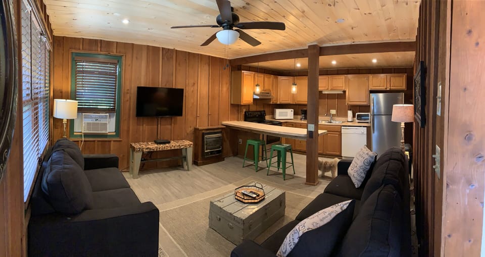 Living room and full kitchen featuring fireplace, TV, and SS appliances.