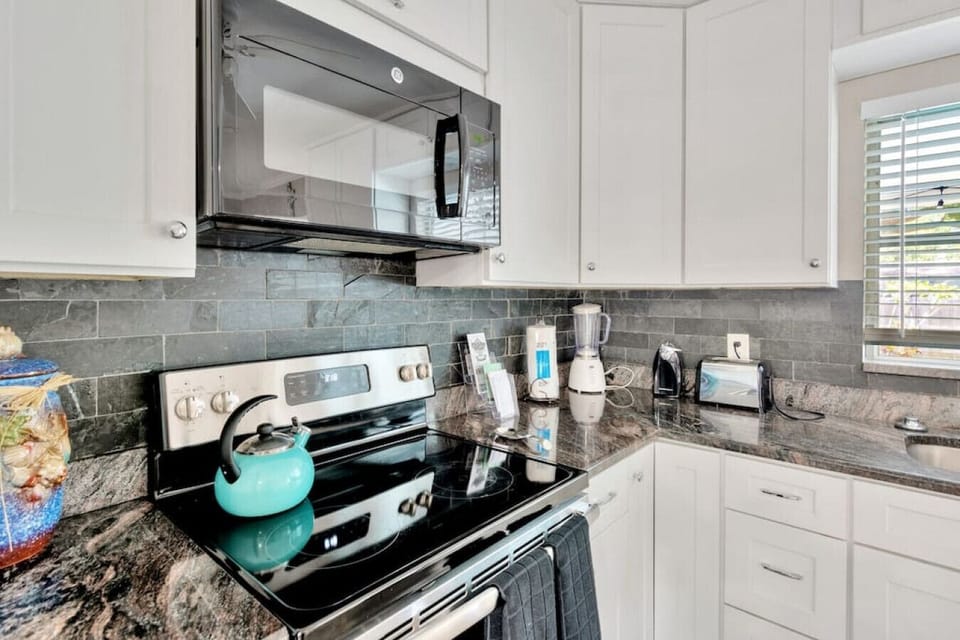 Glasstop stove and overhead microwave.