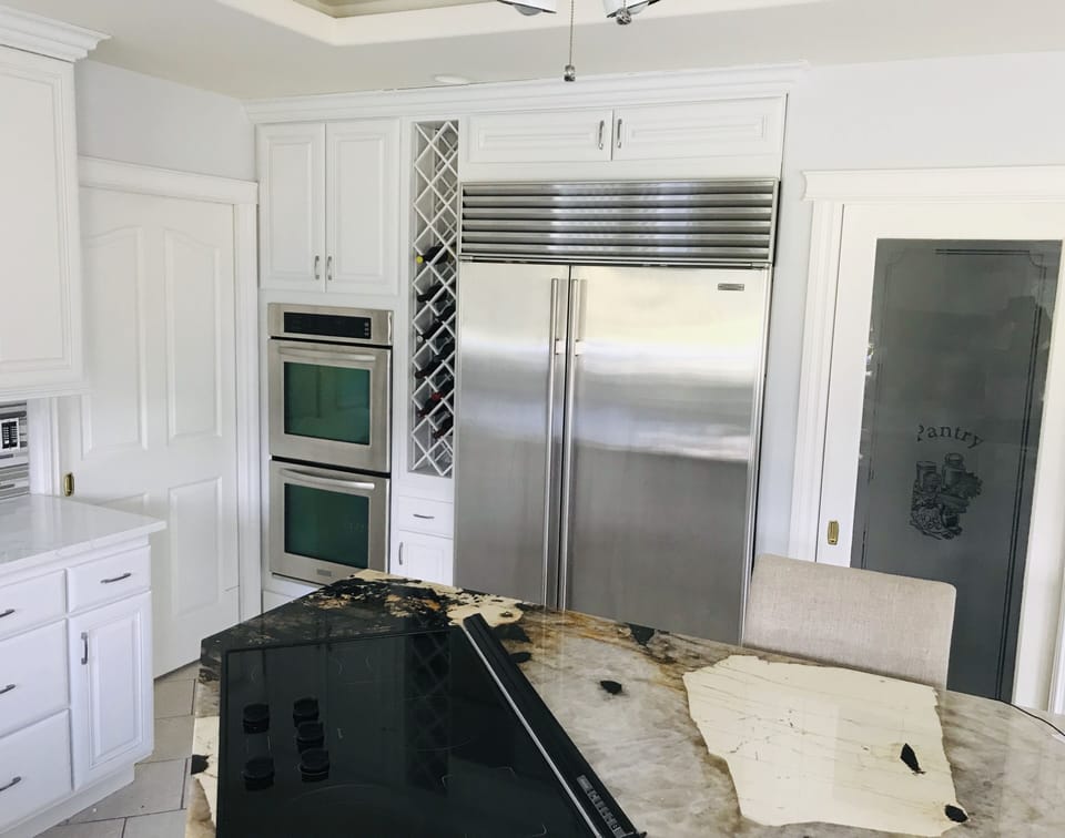 Dual kitchenAid Oven and large sub-zero refrigerator.