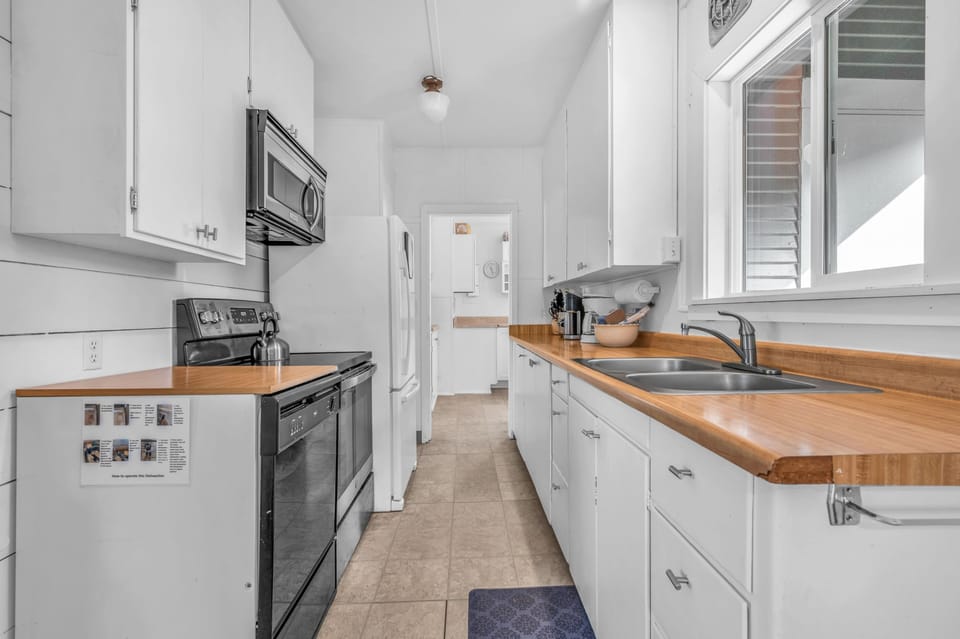 Your fully equipped galley kitchen features warm wood countertops, stainless appliances, and everything you need to create memorable meals during your stay.
